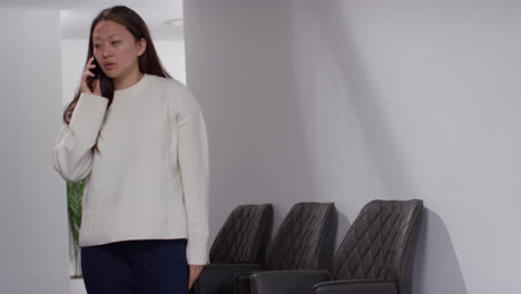 Angry-Anxious-Or-Stressed-Woman-Having-Argument-On-Mobile-Phone-At-Work-In-Office-Building-8